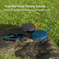 Two wireless speakers on a rock with grass in the background, featuring text about TWS connection and wireless stereo sound.
