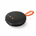 Black portable speaker with orange handle on a white background